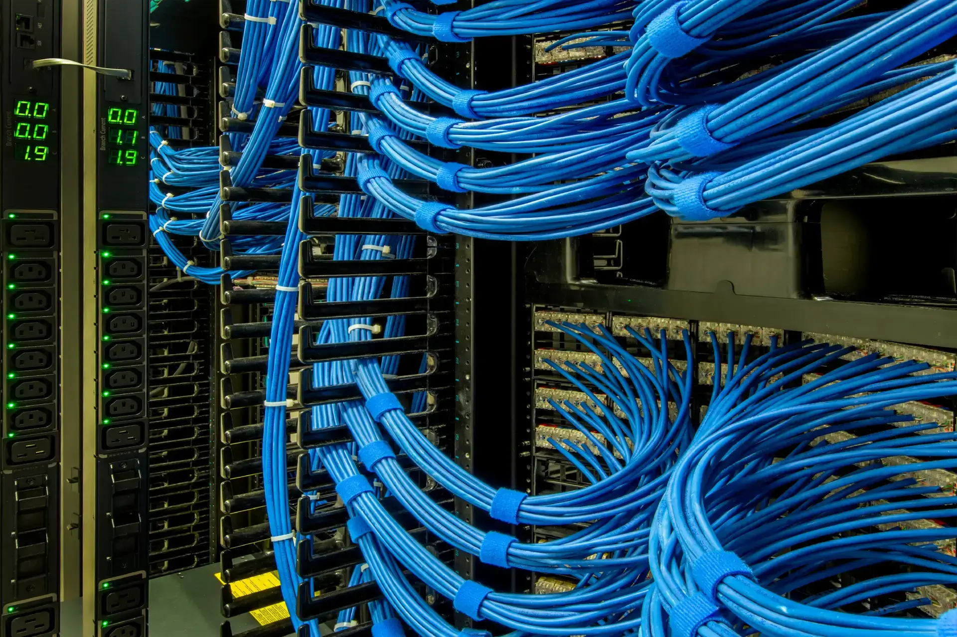 Data center with organized blue network cables.